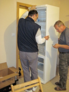 Tibi and Gusti had to remove the fridge door in order to move it so I can easily open the door.  The delivery men somehow got it in place but then the fridge door, and the kitchen door hit each other!  The men moved it across the room for me.